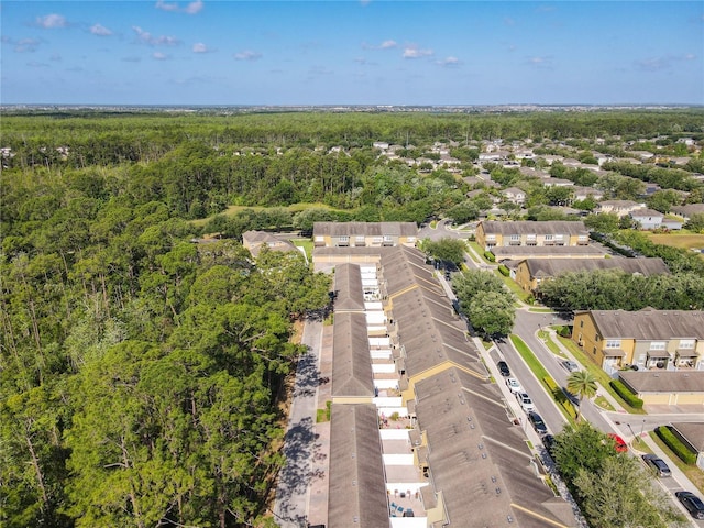 birds eye view of property with a view of trees