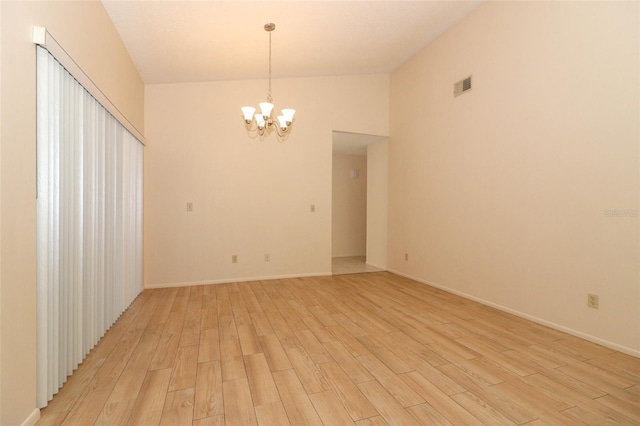 406 Red Coat Ln, Orlando, FL 32825 - spare room with a chandelier, light wood-style flooring, and baseboards