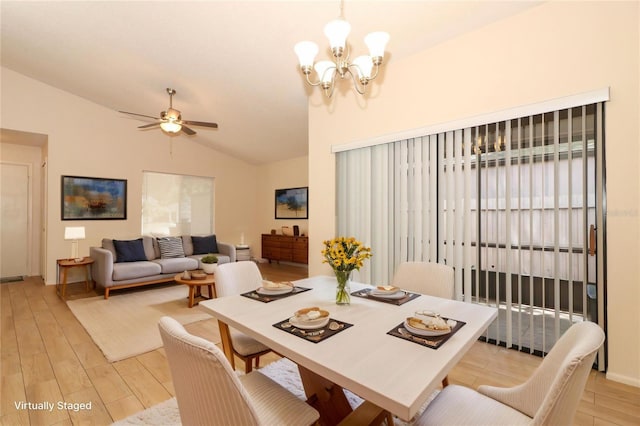 406 Red Coat Ln, Orlando, FL 32825 - dining space featuring lofted ceiling, light wood-type flooring, a ceiling fan, and a chandelier