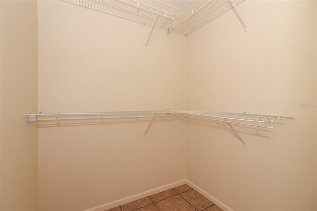 406 Red Coat Ln, Orlando, FL 32825 - walk in closet with light tile patterned floors