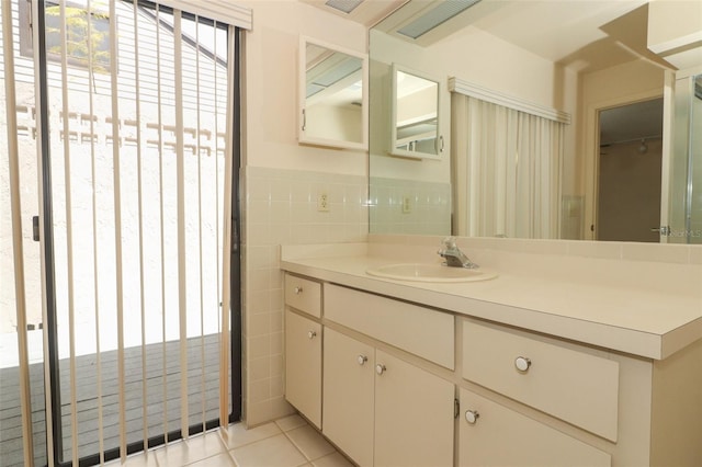 406 Red Coat Ln, Orlando, FL 32825 - bathroom featuring tile patterned floors, tile walls, and vanity