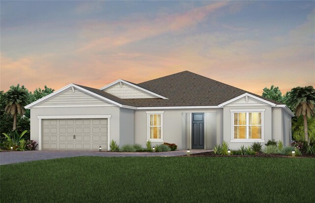 single story home featuring roof with shingles, driveway, an attached garage, a yard, and stucco siding