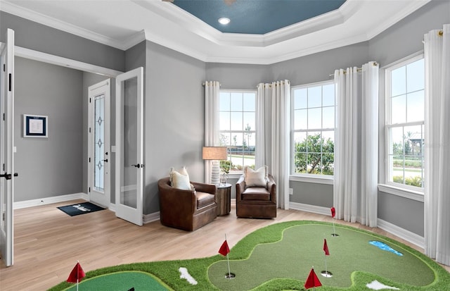 rec room featuring plenty of natural light, baseboards, wood finished floors, and crown molding