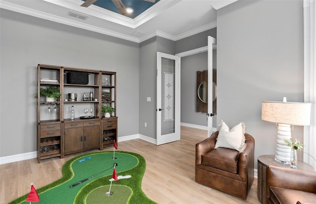 interior space featuring light wood finished floors, visible vents, ornamental molding, french doors, and baseboards