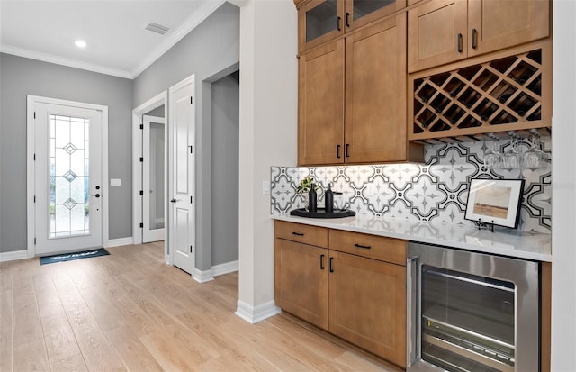 bar with a dry bar, wine cooler, tasteful backsplash, visible vents, and crown molding
