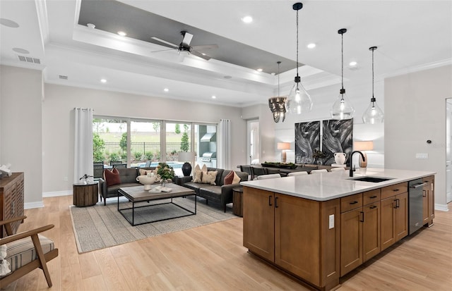 kitchen featuring open floor plan, visible vents, a sink, and ornamental molding