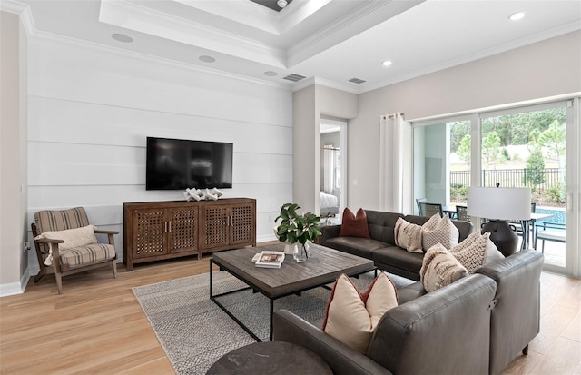 living room with ornamental molding, light wood-style floors, visible vents, and recessed lighting