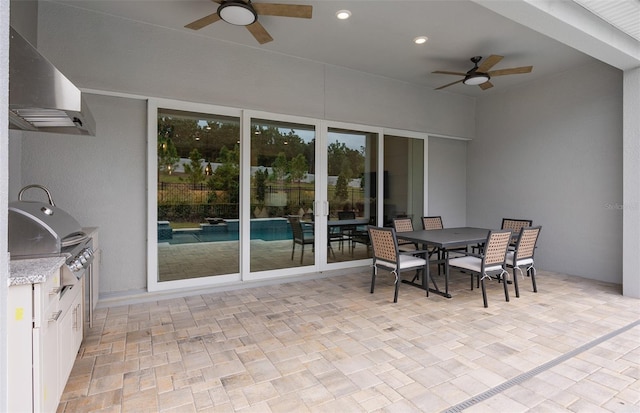 view of patio / terrace featuring grilling area, a ceiling fan, outdoor dining space, and area for grilling