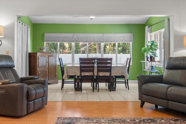 dining space featuring baseboards and light tile patterned floors