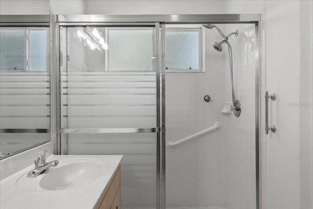 bathroom featuring vanity and a stall shower