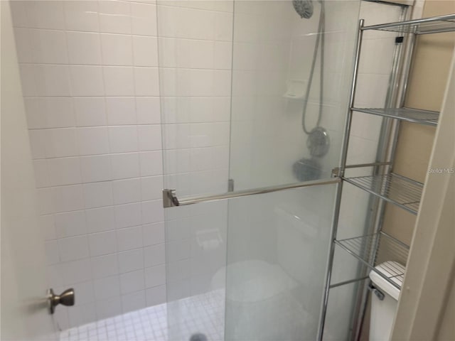 full bathroom featuring toilet and a stall shower