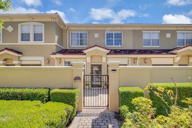 2840 Bella Vista Dr, Davenport, FL 33897 - view of front of property featuring stucco siding, a gate, a tiled roof, and a fenced front yard