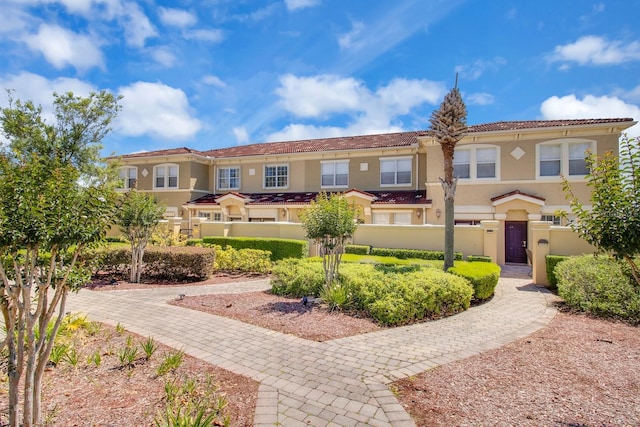 2840 Bella Vista Dr, Davenport, FL 33897 - view of front of property featuring stucco siding, a tile roof, a gate, and a fenced front yard