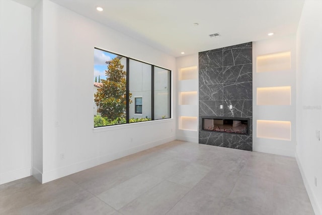16825 Bolsena Dr, Montverde, FL 34756 - unfurnished living room featuring recessed lighting and a premium fireplace