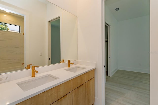 16825 Bolsena Dr, Montverde, FL 34756 - full bathroom featuring double vanity and wood finished floors