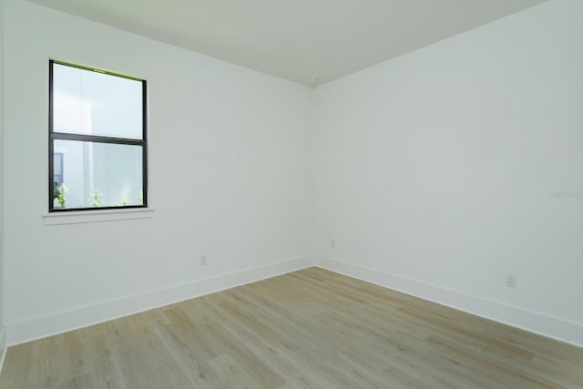 16825 Bolsena Dr, Montverde, FL 34756 - spare room featuring baseboards and light wood-type flooring