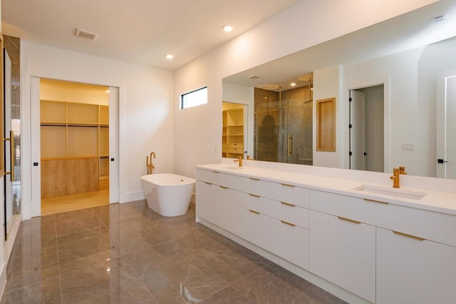 16825 Bolsena Dr, Montverde, FL 34756 - full bathroom with a spacious closet, double vanity, a shower stall, marble tiled flooring, and recessed lighting