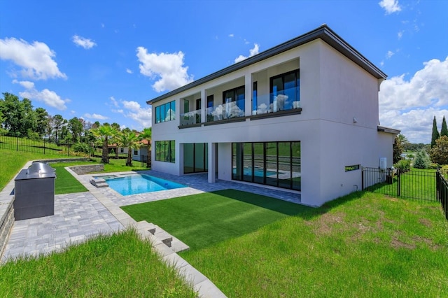 16825 Bolsena Dr, Montverde, FL 34756 - back of house featuring a patio, stucco siding, a fenced backyard, and a balcony