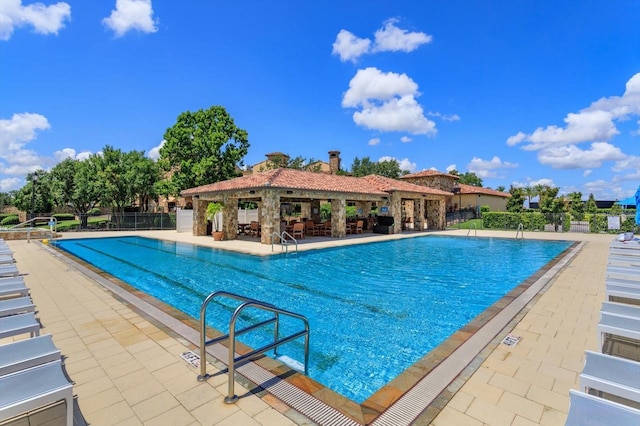 16825 Bolsena Dr, Montverde, FL 34756 - community pool featuring a patio area