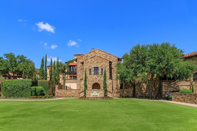16825 Bolsena Dr, Montverde, FL 34756 - view of front of house featuring stone siding and a front lawn