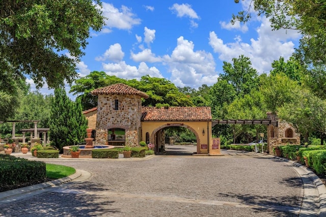 16825 Bolsena Dr, Montverde, FL 34756 - view of front of property featuring stone siding, stucco siding, and a tiled roof