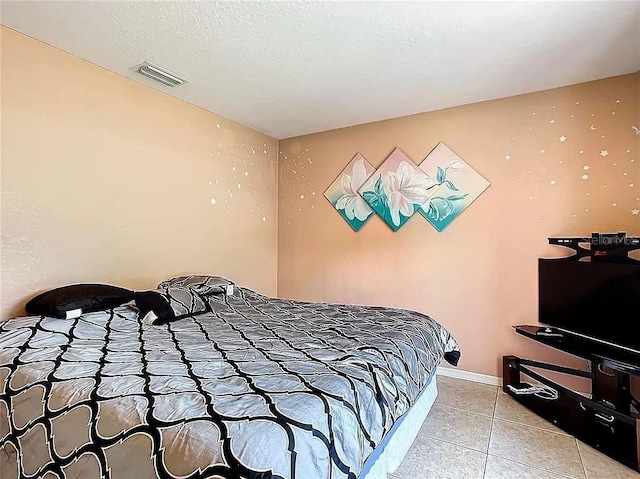 7721 SW 130th Ln, Ocala, FL 34473 - bedroom featuring baseboards, visible vents, and light tile patterned floors