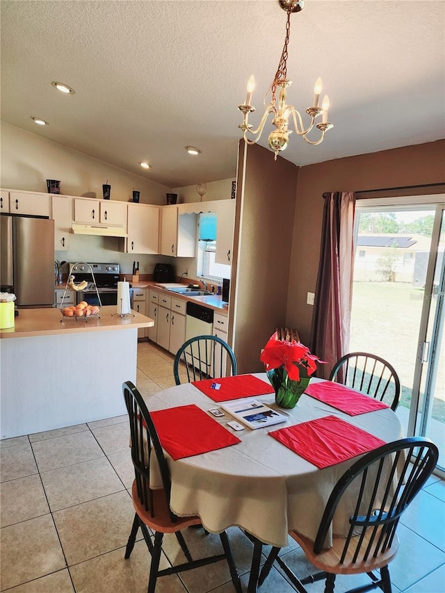 7721 SW 130th Ln, Ocala, FL 34473 - dining room with vaulted ceiling, a textured ceiling, a notable chandelier, and light tile patterned floors