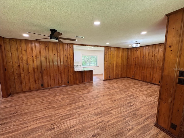unfurnished room featuring recessed lighting, wood finished floors, visible vents, a textured ceiling, and ceiling fan
