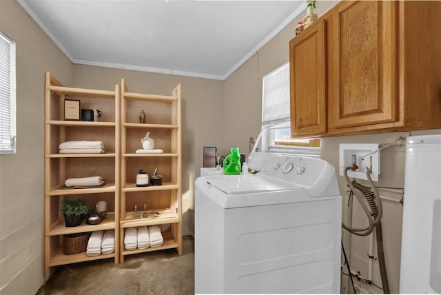 clothes washing area featuring hookup for a washing machine, ornamental molding, and cabinet space