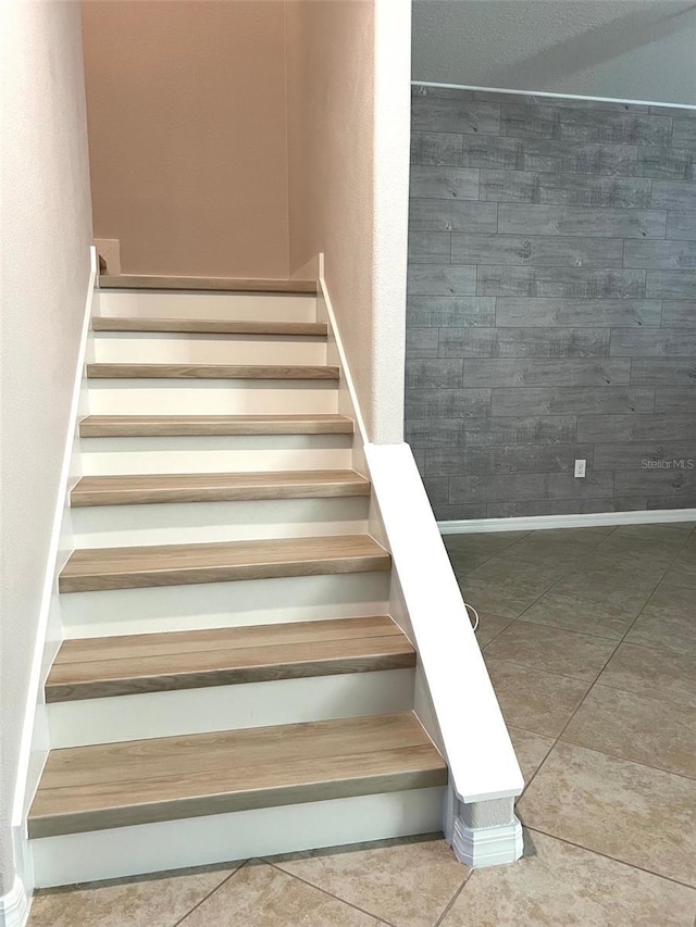 staircase with tile patterned floors