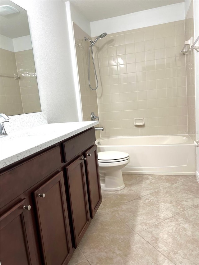 bathroom featuring bathing tub / shower combination, vanity, tile patterned flooring, and toilet