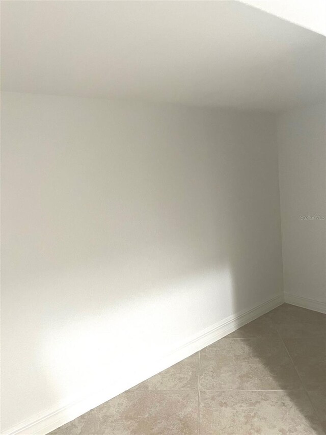 carpeted empty room with baseboards