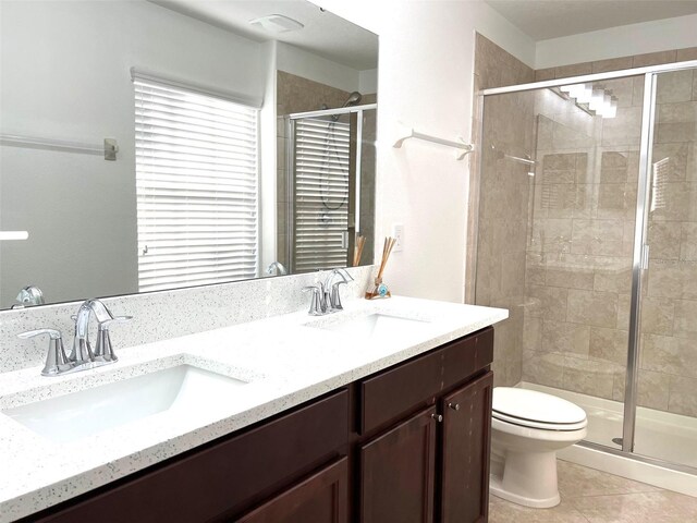 bathroom featuring a shower stall, toilet, and a sink