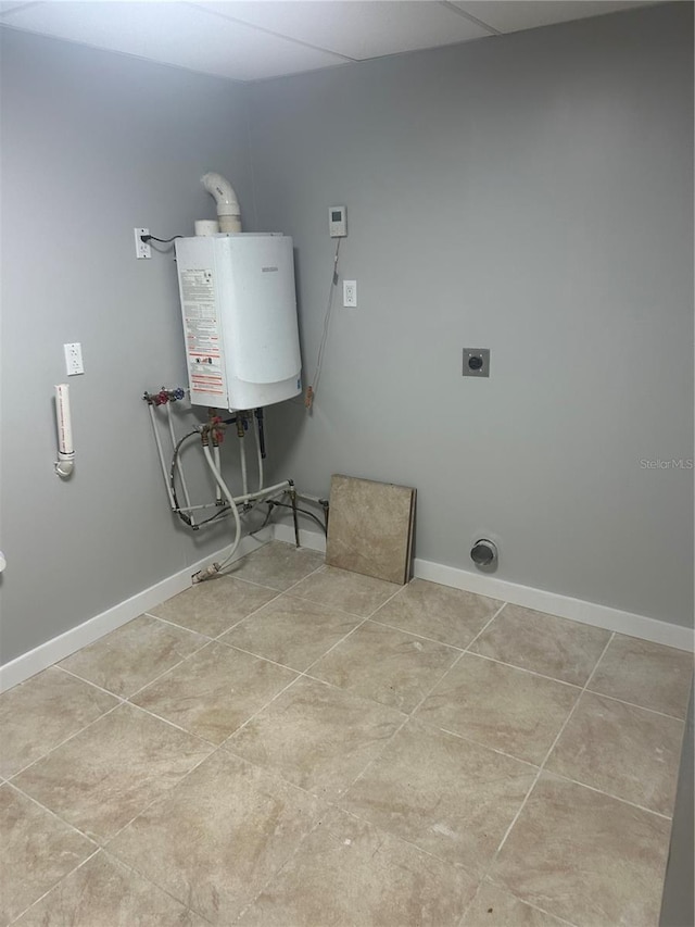 clothes washing area featuring water heater, laundry area, baseboards, electric dryer hookup, and washer hookup