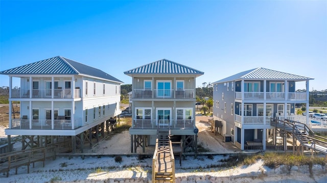 rear view of property featuring stairway and a balcony