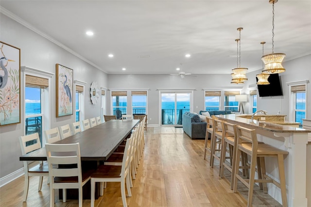 dining room with light wood finished floors, baseboards, recessed lighting, a ceiling fan, and crown molding