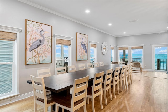 dining area with baseboards, ornamental molding, light wood finished floors, and recessed lighting