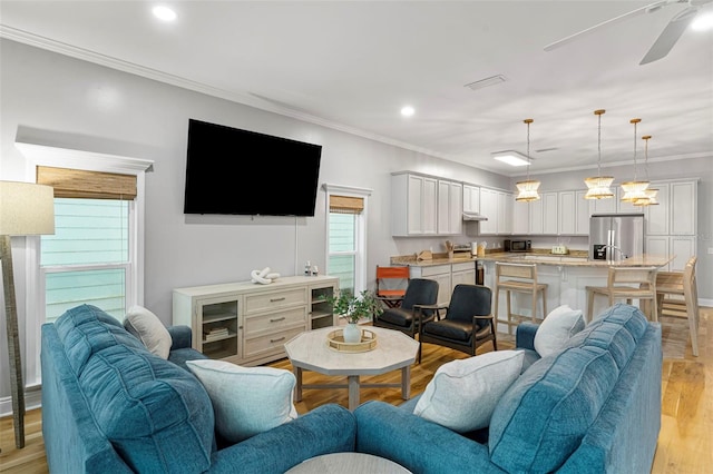 living room with ceiling fan, crown molding, light wood-type flooring, and recessed lighting