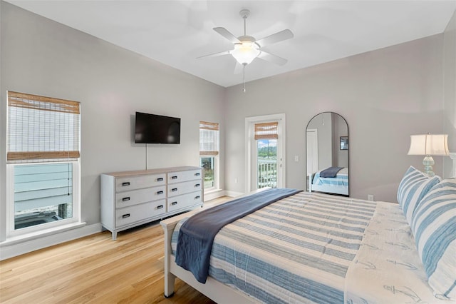 bedroom featuring a ceiling fan, baseboards, access to outside, and light wood-style flooring