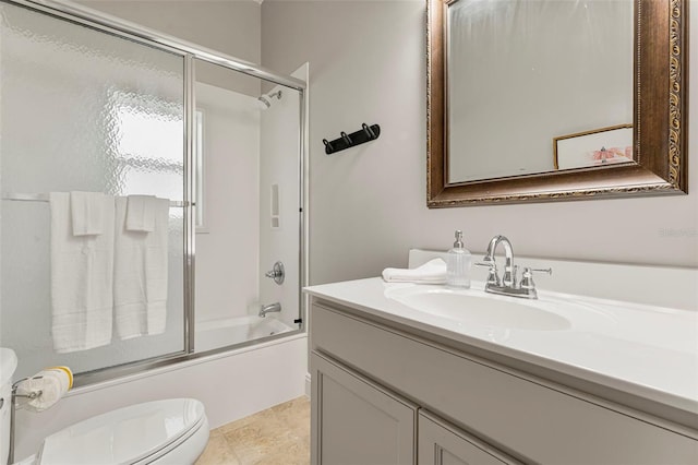 bathroom featuring bath / shower combo with glass door, toilet, and vanity