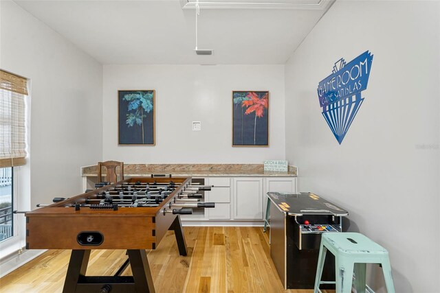 playroom featuring light wood finished floors and visible vents