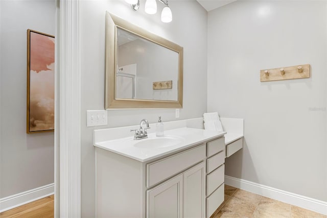 bathroom featuring baseboards and vanity