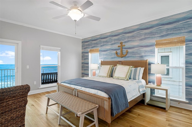 bedroom with an accent wall, crown molding, wallpapered walls, baseboards, and access to outside