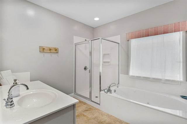 bathroom with a bath, vanity, and a shower stall