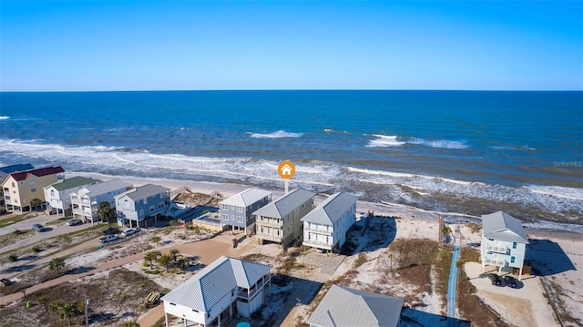 drone / aerial view with a beach view, a residential view, and a water view