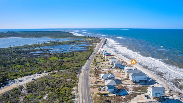 birds eye view of property with a view of the beach and a water view