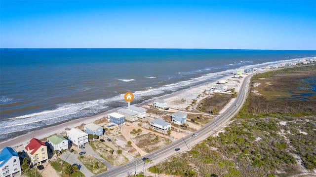 birds eye view of property with a view of the beach and a water view