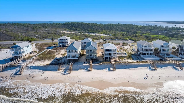 drone / aerial view with a beach view and a water view