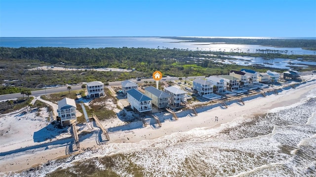 birds eye view of property with a beach view and a water view