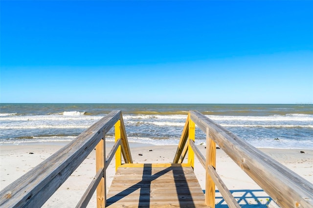 surrounding community featuring a view of the beach and a water view